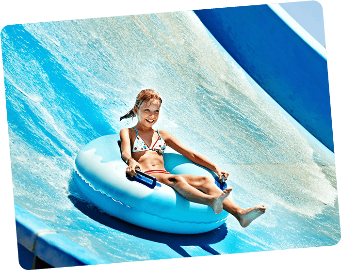 A girl in white bikini sitting on an inflatable raft.