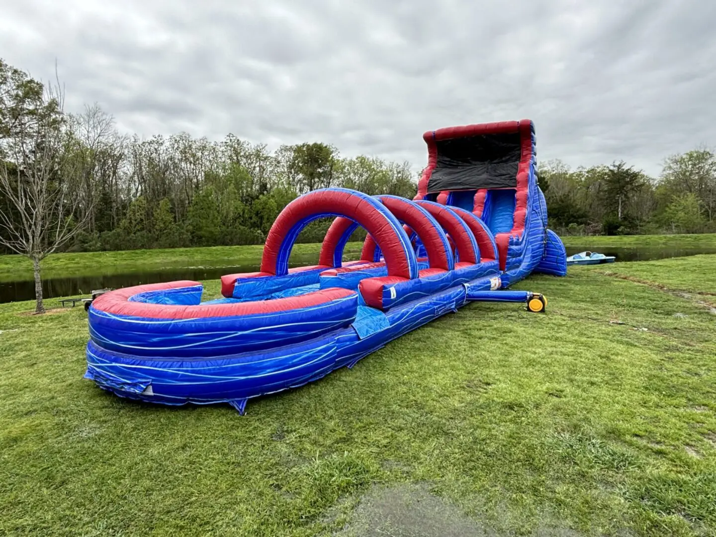 A large inflatable water slide in the grass.