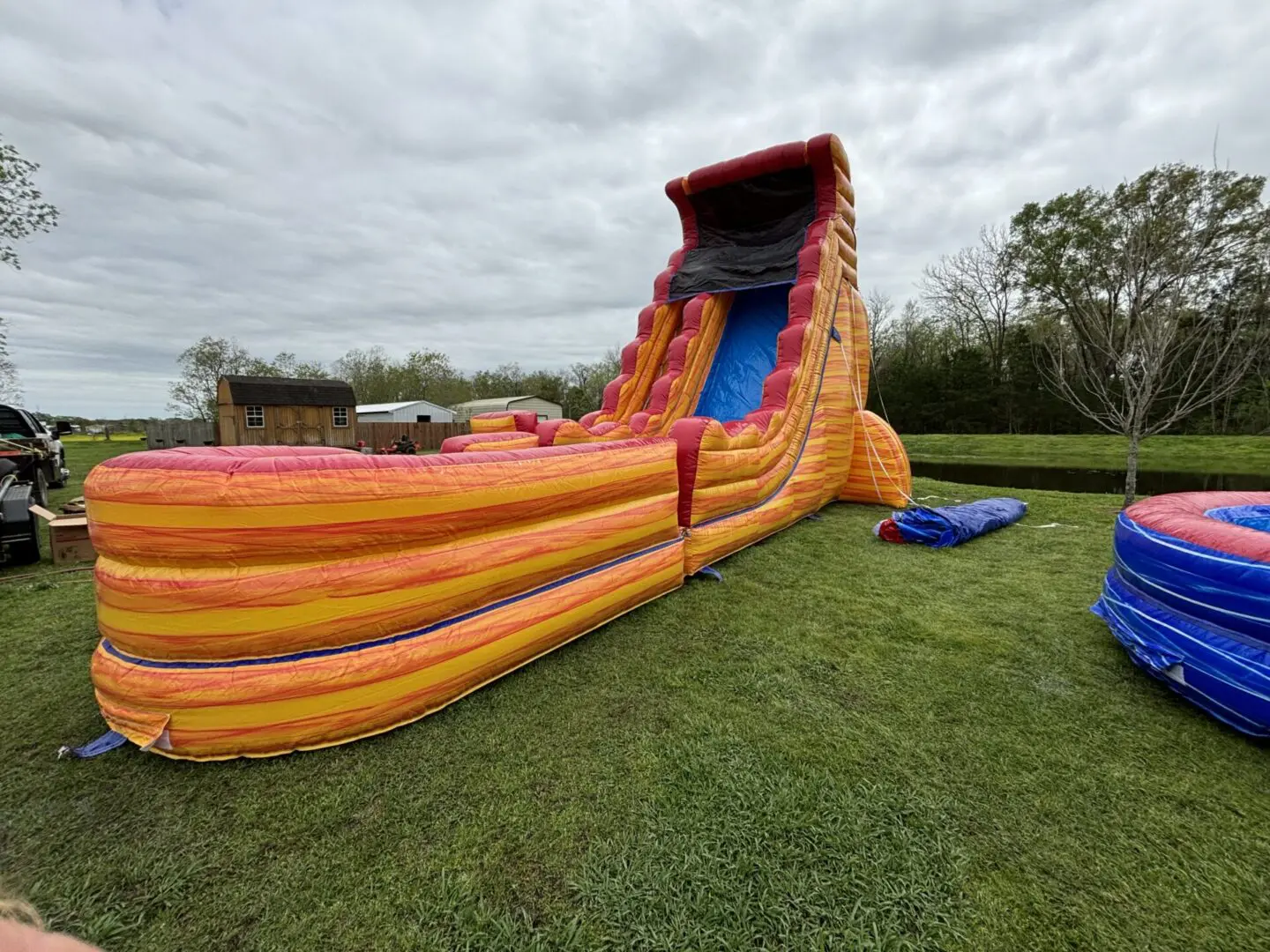 A large inflatable slide in the grass.
