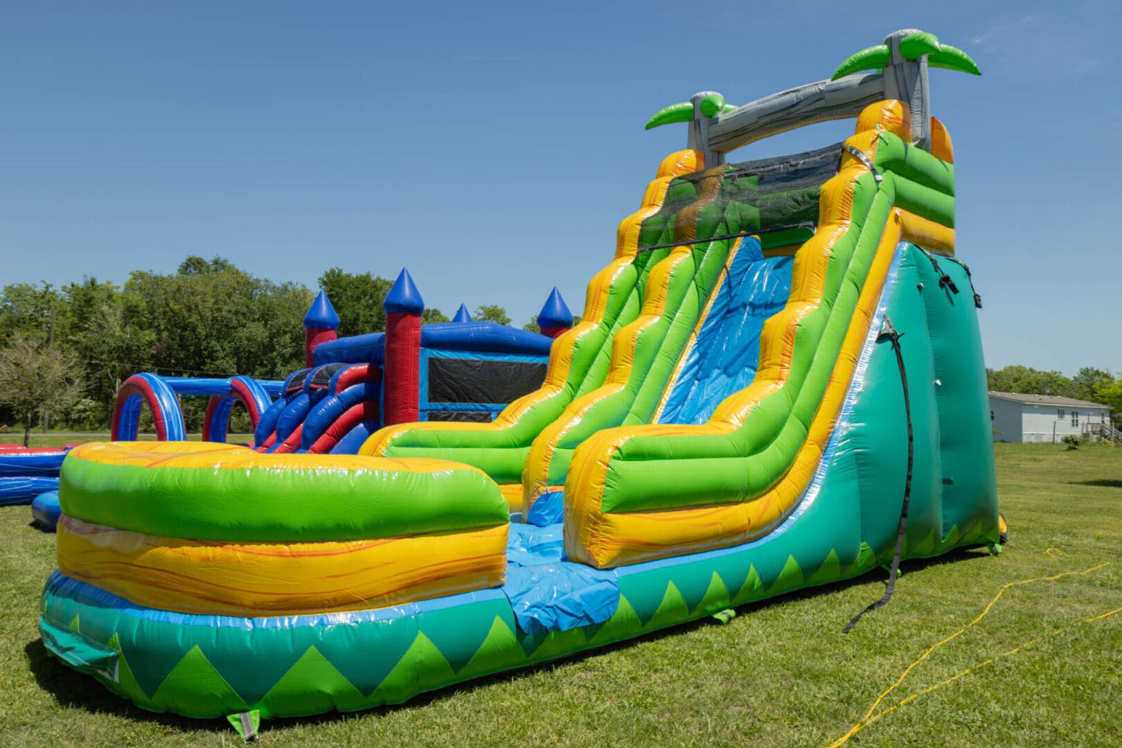 A large inflatable slide in the grass.
