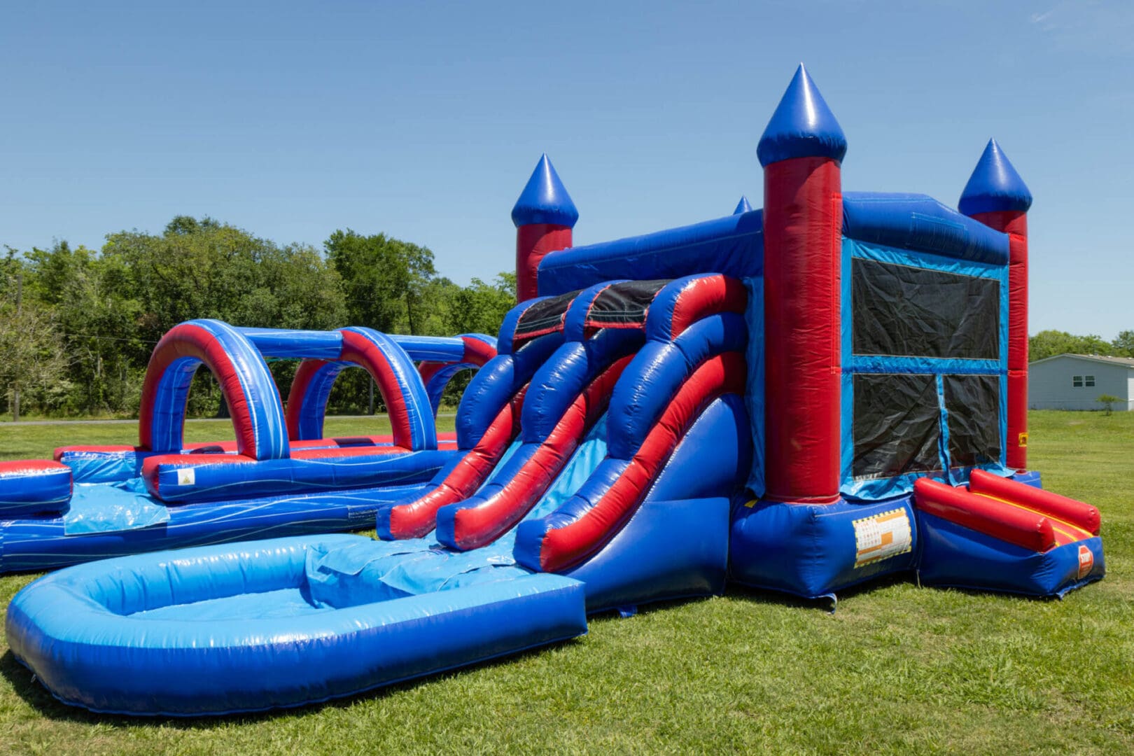 A blue and red inflatable slide with water.